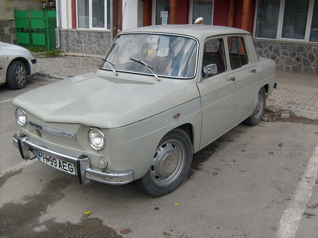 A grey Dacia 1100 sedan on Romanian plates, three-quarter front view