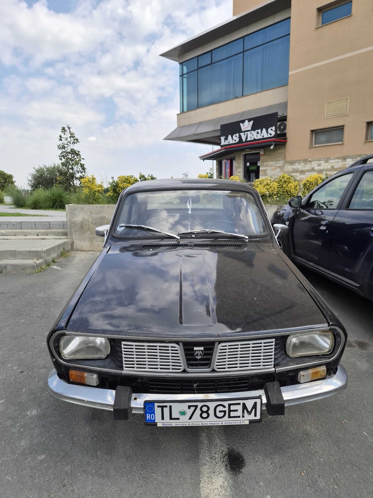 Front view of a black Dacia 1300 LS on Romanian plates in a car park
