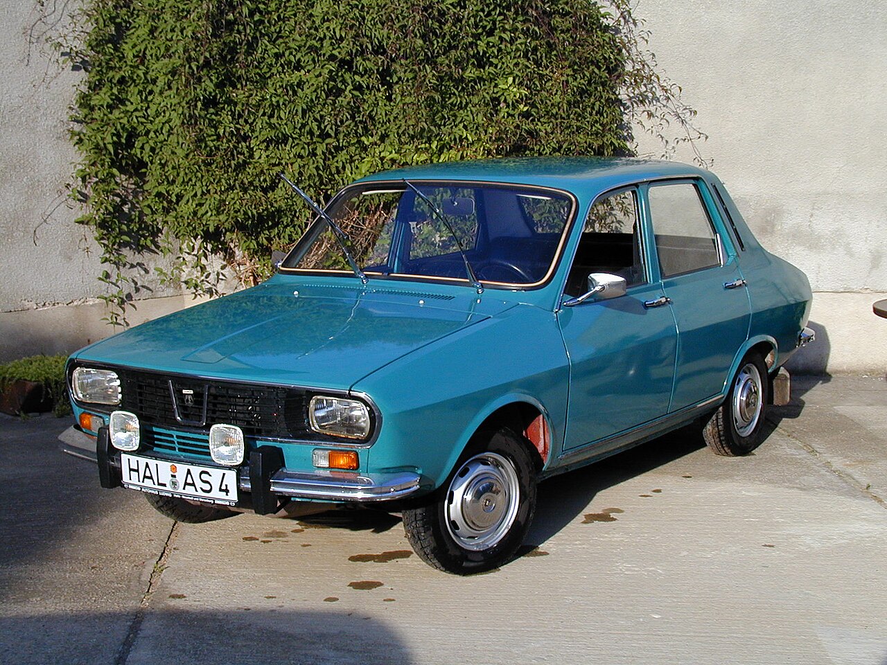 A teal Dacia 1300 sedan, three-quarter front view